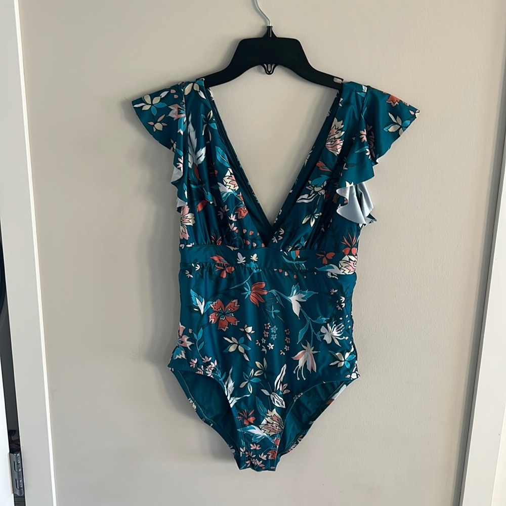 Ruffle cap sleeve, plunging V neckline, vintage, inspired floral onepiece suit.